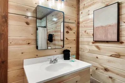 Soak away trail miles in this deep soaking tub — warm wood walls, spa-clean finishes, and all the silence of the Smokies outside your window.