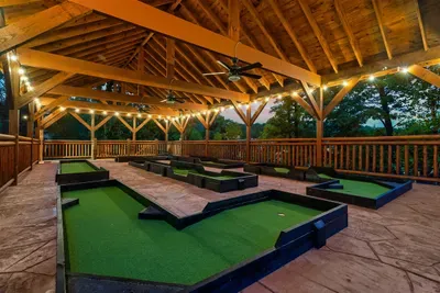 Golden string lights, a full mini golf course, and cornhole at the ready — your covered outdoor pavilion turns every night into an event. Rain never cancels plans here.