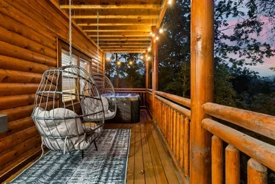 Hanging egg chair, a private hot tub, string lights, and a cotton-candy Smoky Mountain sky — your evening plans are already decided. All you have to do is show up.