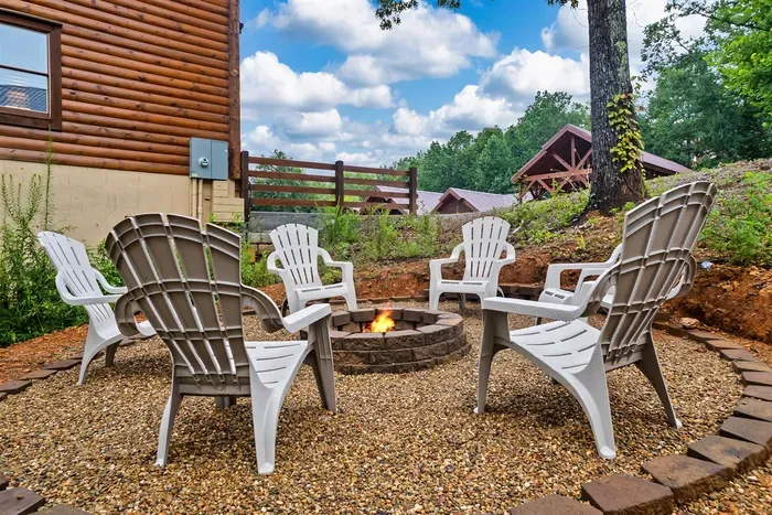 Private fire pit ringed with Adirondack chairs — s'mores, stories, and starlit Smoky Mountain skies. The night your group talks about for years.