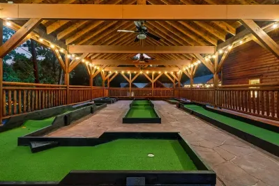 Private mini golf under a timber pavilion, glowing with string lights at dusk — the evening plans write themselves. No cover charge. No crowds. Just your crew.