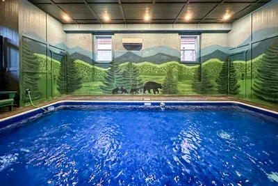 Full-size private indoor pool — all yours, all weekend. Mountain mural surrounds you while the kids wear themselves out. Wins for everyone.