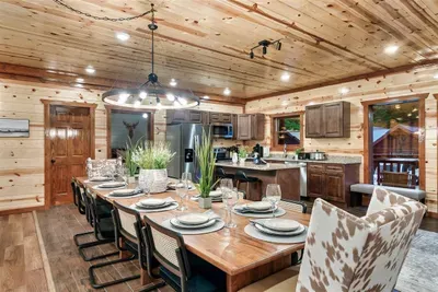 Open-plan dining and kitchen built for a crowd — dining table for 12 flows right into a fully equipped chef's kitchen. The only thing missing is your favorite meal in progress.