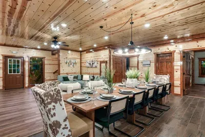Seats the whole crew at one table — cowhide upholstered chairs, knotty pine ceiling, and enough elbow room for the most spirited group dinners. Pass the dishes, start the stories.