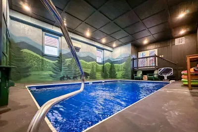 Private indoor pool with hand-painted Smoky Mountain mural — swim, splash, and stay in the mountains even when you're inside. No crowds. No closing time.