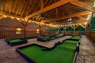 Nine holes of private mini golf under a handcrafted timber roof lit by warm string lights — bragging rights, rematches, and mountain air included with every round.