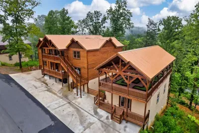 Grand timber-frame cabin with multi-level decks tucked into the Smoky Mountain canopy — your group's basecamp for an unforgettable mountain escape.