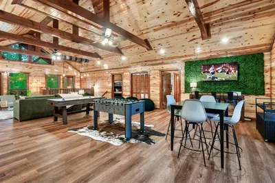 Pool table, foosball, living green wall, and a game-day TV setup — your cabin's entertainment floor is built to keep the whole crew happy, all weekend long.
