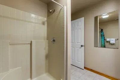 Walk-in shower with a bench nook and clean tile throughout. Rinse the trail dust off and start the evening feeling completely human again.