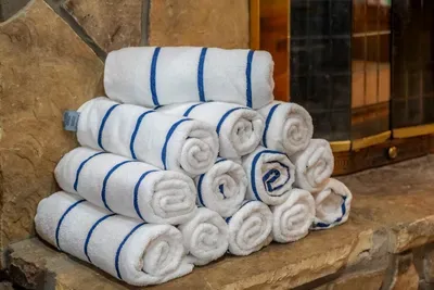 Fresh rolled towels stacked and waiting on arrival. Hotel-level linens in a real log cabin — the small detail guests mention in reviews every time.