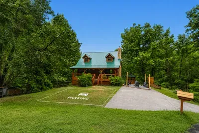Log cabin set on a private green lawn with hardwoods all around. Room to play in the yard, and not a neighbor's window pointed your way. extra parking space in front of the cabin.