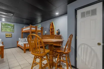 Lower-level kitchenette and dining nook — snacks, drinks, and a table right off the game room. No stair climbing between the fun and the fridge.