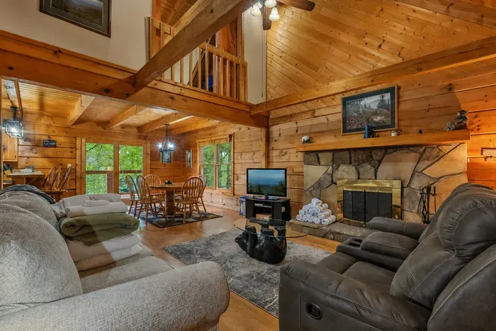 Windows full of green, seating for the whole crew. Real log construction with the warmth to match — this is the heart of the cabin every evening.