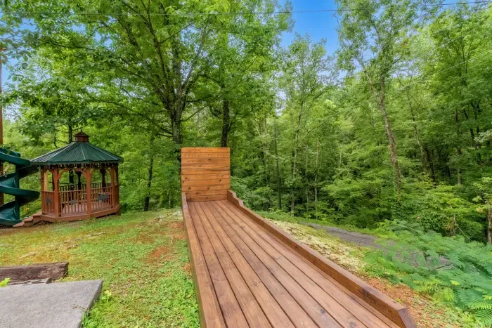 Outdoor bowling lane built right into the hillside, backstop and all. Roll a frame in the mountain air while the fire pit gets going — the amenity nobody expects and everybody remembers.