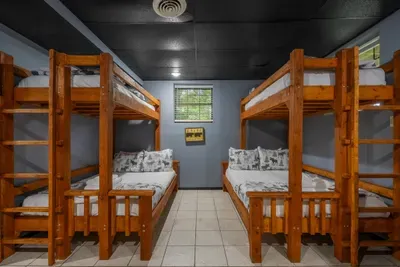 Two sets of solid wood bunks in one room. The kids claim it before the car doors close, and the whole family still sleeps under one roof.