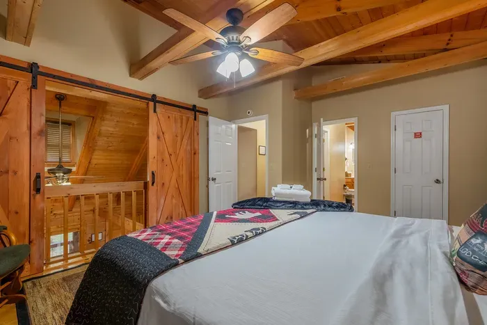 Barn door, plaid bedding, and warm wood in every direction. Private, tucked away, and quiet enough to sleep straight through a mountain sunrise.