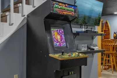 Arcade cabinet loaded with classics and set on free play. No quarters, no waiting — just high scores and a rivalry that lasts the whole week.