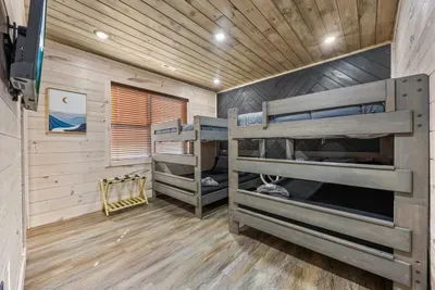Spacious bunk room with two sets of queen-over-queen beds — perfect for kids or groups.