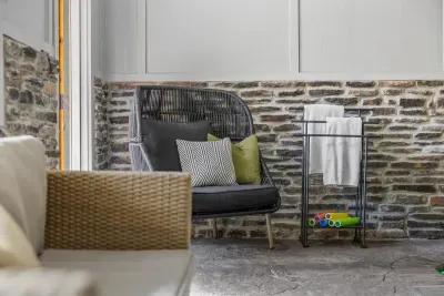 Cozy corner with plush pillows and modern stone accents — the perfect spot to relax after a swim.