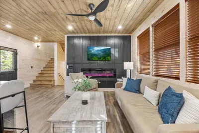 The main living area features a fireplace and Smart TV, creating a warm and inviting space for group gatherings.