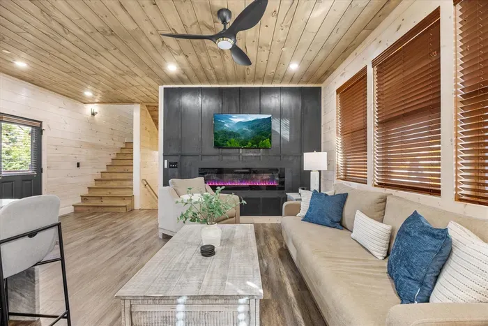 The main living area features a fireplace and Smart TV, creating a warm and inviting space for group gatherings.