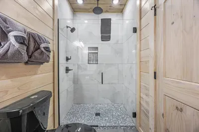 This bathroom offers a spacious and functional layout with a tub/shower combo.