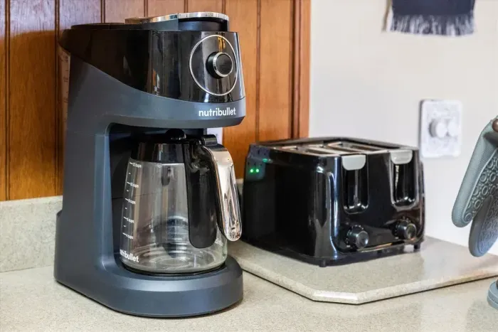 Kitchen is stocked with coffee maker and toaster.