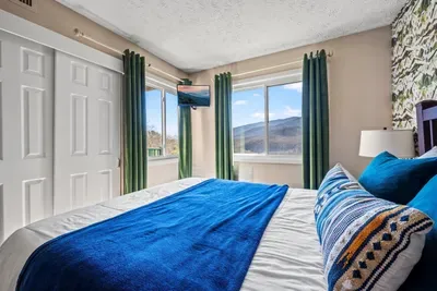 Master bedroom includes a queen bed and cable TV.