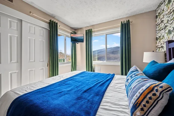 Master bedroom includes a queen bed and cable TV.