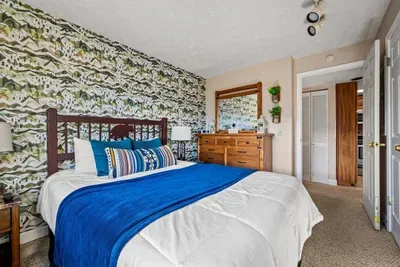 Master bedroom includes queen bed and cable TV.