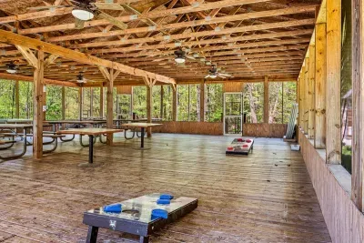 Community pavilion that includes picnic tables, yard games, and charcoal grills.