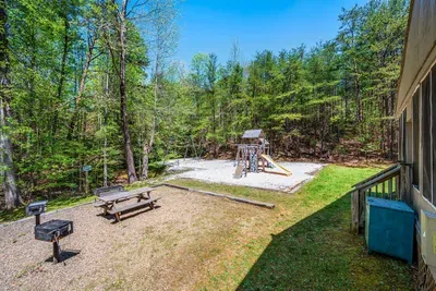 Community playground with picnic area and charcoal grill.