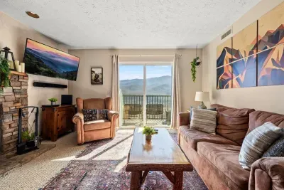 Living room includes a full sleeper sofa and cable TV.