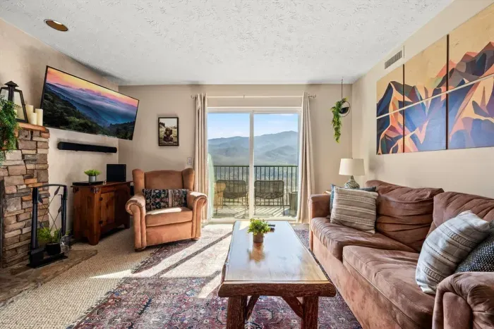 Living room includes a full sleeper sofa and cable TV.