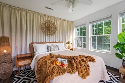 Wake up to breakfast in bed, dappled tree light, and a chunky knit throw that makes leaving feel impossible — the boho bedroom