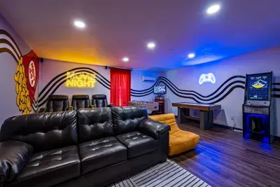 Movie first, then foosball — gather the whole family in one epic room. Private theater with leather recliners, glowing neon & a game table. No one's leaving this room tonight.