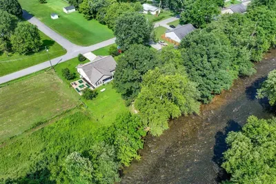 A stunning bird’s-eye view of the home, surrounded by nature and peaceful scenery.