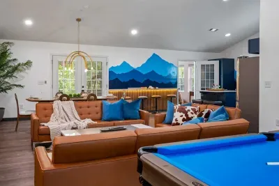 From the pool table to the leather lounge to the glowing wet bar — every corner of this open-concept great room pulls you in a different direction, and that's exactly the point.
