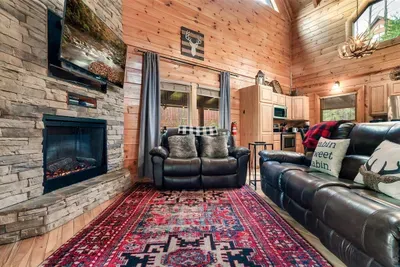 Rustic wood, soft leather, and a glowing fire — everything you need for a relaxing evening.