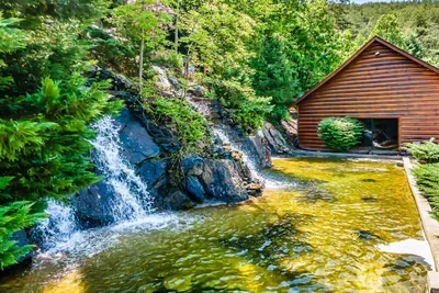 Scenic resort setting with waterfalls and lush greenery.