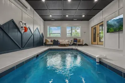 A wider look at the private indoor pool, with plenty of room to splash, float, and catch a game on the pool TV.