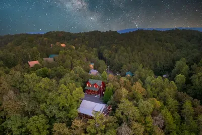 Aerial view of Bearfoot Haven within its wooded mountain neighborhood.