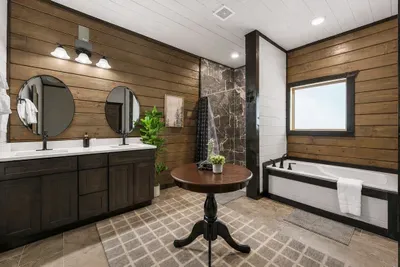 Primary bathroom with double vanity, soaking tub, and separate walk-in shower.