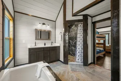 Family bathroom with double sinks, a tub, and separate shower—helpful when everyone is getting ready at once.