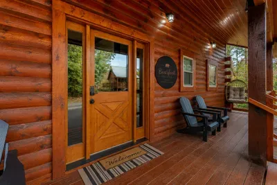 Arrive to a welcoming covered porch with Bearfoot Haven’s signature entrance and a quiet place to sit among the trees.