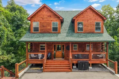 This aerial angle shows the cabin’s three levels of covered decks and the forest surrounding them.