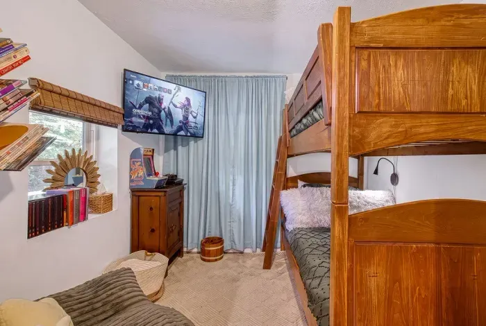 Bunk room built for the kids (and the kid in you) — solid wood bunks, a smart TV for rainy afternoons, and enough space that nobody's fighting over the top bed.