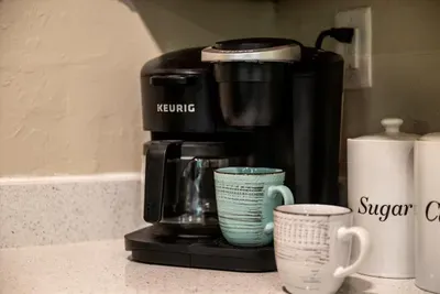 Keurig coffee bar stocked and ready before you are. Grab a mug, step onto the deck, and take that first sip while the mist is still sitting low in the trees. Best few minutes of the day.