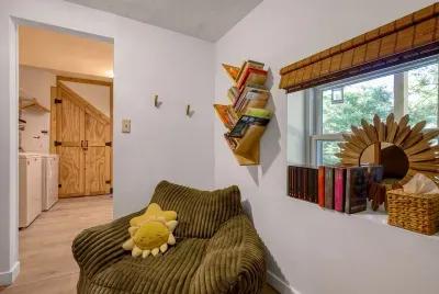 A tucked-away reading nook with a stocked bookshelf and a couch made for sinking into. Rainy afternoons, quiet mornings, or the one spot the kids claim as theirs.
