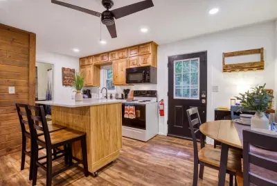 Butcher-block island with bar seating, full-size range, and everything you need to actually cook up here. Pull up a stool — the kitchen always ends up being the party.